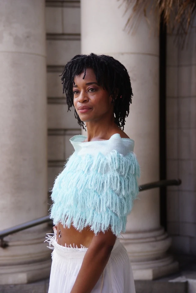 Designer fashion in pale blue with a sculptural fringed silhouette